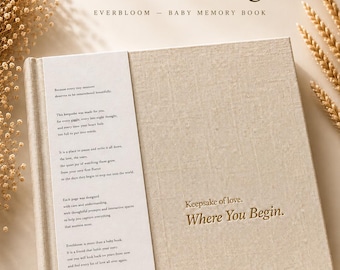 May include: A beige linen-textured baby memory book titled Where You Begin, featuring a white paper wrap with printed text about capturing memories. The cover is embossed with the words Keepsake of love, Where You Begin in a dark font.