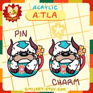 May include: Acrylic pin and charm set featuring a cartoon character in a teacup. The character has white fur, brown horns, and a blue arrow marking. The teacup is teal with a floral design. The text "PIN" and "CHARM" are visible.