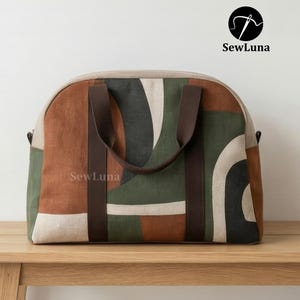 Handmade arched duffle bag sewing pattern featuring an earthy geometric print in terracotta, forest green, and charcoal. The modern weekender bag has dark brown wrap-around straps and sits on a beige background.
