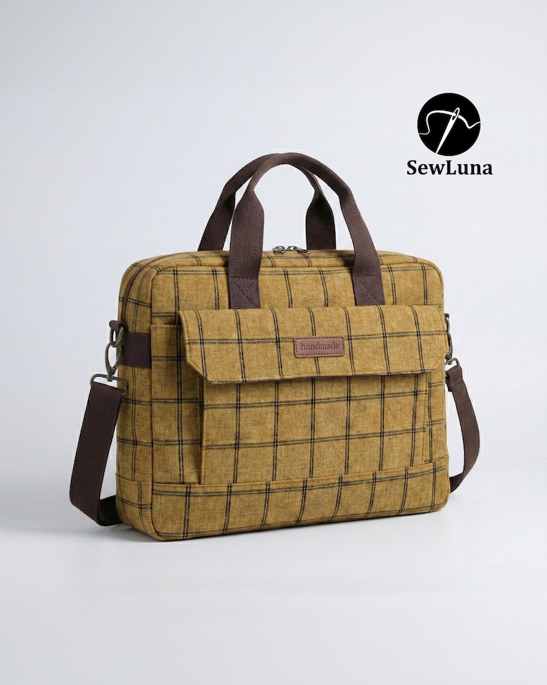 Mustard yellow plaid handmade laptop bag sewing pattern featuring brown webbing handles, an adjustable shoulder strap, a top zipper, and a front flap pocket, displayed on a clean white background.
