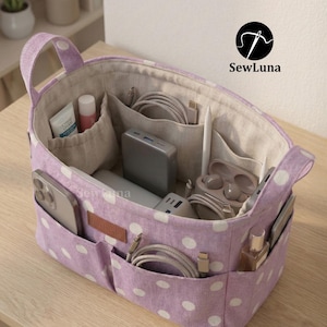May include: A lavender and white polka dot organizer bag with multiple pockets and compartments. The bag contains various items, including a phone, charger, and cosmetics. The bag has handles and the text "SewLuna" is visible.