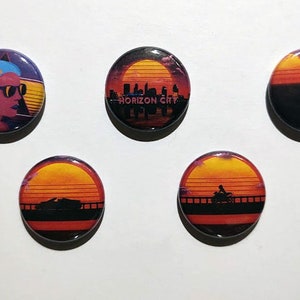 May include: Set of five round buttons with retro sunset designs. One button features a woman with blue hair and sunglasses. Other buttons display cityscapes, vehicles, and a motorcycle silhouette against a sunset.