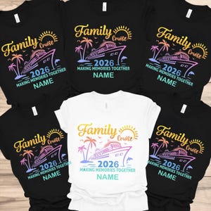 May include: A collection of black and white t-shirts with a colorful cruise ship design. The shirts feature the words "Family Cruise 2026" and "Making Memories Together" with space for a name. The design includes a sun, palm trees, and a dolphin.