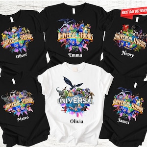 May include: A collection of black and white t-shirts featuring a colorful graphic design with the text "UNIVERSAL STUDIOS" and various character illustrations. Each shirt has a name printed below the graphic, including "Oliver", "Emma", "Henry", "Mateo", "Olivia", and "James".