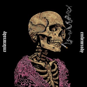 May include: An embroidered design on a black background featuring a tan skull smoking a cigarette with white smoke rising. The skeleton wears a pink lace garment over its ribcage. The text "embroready" is printed on both sides of the image.