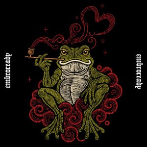 May include: An embroidered graphic on a black background featuring a green frog holding a pipe with red smoke swirling into a heart shape. The text "embroready" is printed in white on both the left and right sides of the central frog illustration.