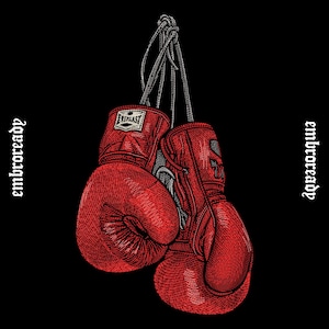 May include: A pair of red boxing gloves hanging against a black background. The gloves are detailed with stitching and the Everlast logo. The word "embroready" is written vertically on both sides of the image.