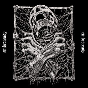 May include: A black and white embroidered patch featuring a screaming skull positioned above two crossed skeletal hands. The design is enclosed in a rectangular frame made of bones and web-like threads, with the text embroready on both sides.