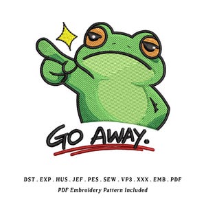 May include: An embroidered design of a green frog with orange eyes and a pointing finger. The frog has a grumpy expression and the words "GO AWAY" are written below in black. A yellow star is next to the frog's finger.