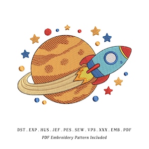 May include: An embroidered design featuring a blue rocket ship with red accents, flying past a brown planet with a ring. The design includes yellow, red, and blue stars and planets. The text at the bottom says "PDF Embroidery Pattern Included."