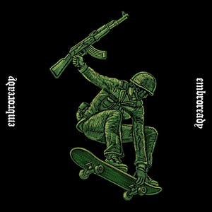 May include: An embroidered graphic on a black background featuring a soldier in a helmet and uniform riding a skateboard while holding a rifle overhead. The text "embroready" is printed vertically on both the left and right sides of the design.