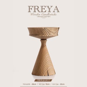 May include: A light brown wooden candlestick with a wide, circular top and a conical base. The text FREYA Wooden Candlesticks is at the top. The base text reads FREYA SA 24117, Height: 28cm, Base Diameter: 15cm, Top Diameter: 20cm.