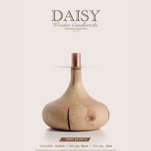 May include: A wooden candlestick labeled DAISY with a wide base, a copper-colored top insert, and visible wood grain. Text includes DAISY Wooden Candlesticks, DAISY ŞA 24112, and measurements: height 13.5cm, base diameter 15cm, and top diameter 2cm.