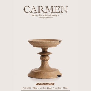 May include: A light brown wooden candlestick labeled CARMEN Wooden Candlesticks. The item features a wide base, a central stem with a rounded detail, and a circular top plate. Text indicates a height of 20 cm, base diameter of 20 cm, and top diameter of 20 cm.