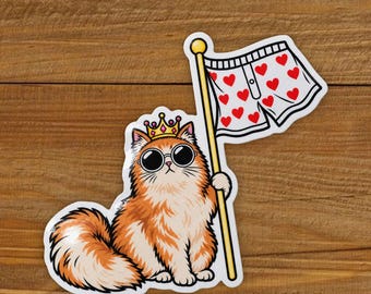 May include: A sticker featuring a fluffy orange cat wearing a gold crown and black round sunglasses. The cat holds a yellow pole with a white flag decorated with a red heart pattern. The illustration has a white border and a die-cut shape.