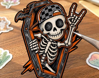 May include: A die-cut sticker featuring a skeleton wearing a black and gray checkered baseball cap, emerging from a black and orange coffin. The skeleton is making a rock-and-roll hand gesture, and a small black bat is perched on the coffin edge.