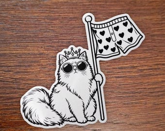 May include: A white sticker featuring a fluffy cat wearing a crown and round sunglasses. The cat is holding a flagpole with a pair of white boxer shorts decorated with a black heart pattern attached to the top. The design is outlined in black.