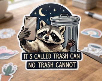 May include: A die-cut sticker featuring a raccoon taking a selfie with a smartphone next to a metal trash can under a night sky with a crescent moon and stars. The text reads: IT'S CALLED TRASH CAN NO TRASH CANNOT in bold black lettering.