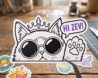 May include: A die-cut vinyl sticker featuring a black and white illustration of a cat wearing a crown and round sunglasses. The cat is waving a paw, and a speech bubble next to its head contains the purple text HI ZEV! in all caps.