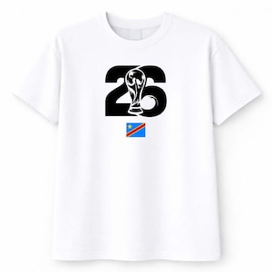 May include: White t-shirt featuring a black graphic of the number 26 with a trophy and the flag of the Democratic Republic of the Congo. The design is centered on the front of the shirt.