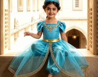 May include: A bright turquoise costume featuring a satin bodice with gold embroidery, puffed sleeves, and matching harem pants. A sheer turquoise overskirt with gold trim, a gold waistband, and a turquoise headband with a blue gem complete the set.