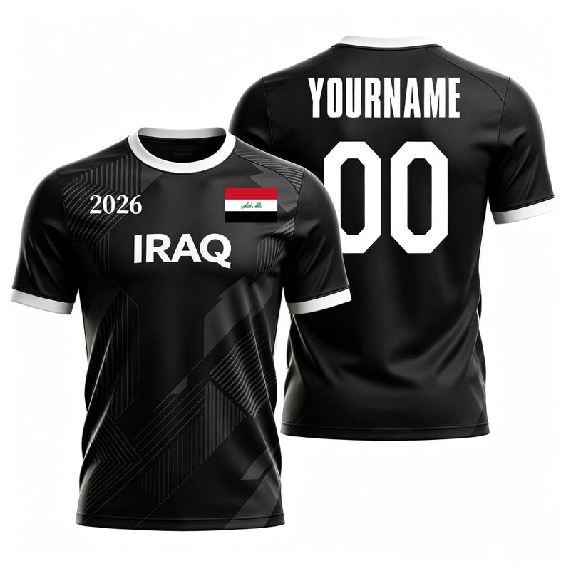 May include: Black soccer jersey with white trim and the text "IRAQ" and "2026". The front of the jersey features the Iraqi flag. The back displays "YOURNAME" and the number "00".