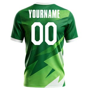 May include: Green and white athletic jersey with the text "YOURNAME" above the number "00". The jersey has a white collar and sleeve cuffs. The design features a geometric pattern in shades of green.