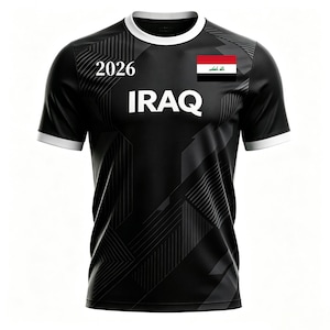 May include: Black soccer jersey with white trim and the word "IRAQ" in large white letters. The number "2026" is above the word "IRAQ". The Iraqi flag is on the right chest.