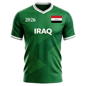 May include: Green soccer jersey with white trim and a V-neck collar. The jersey features the word "IRAQ" in white block letters, the number "2026", and the Iraqi flag on the right chest. The shirt has a striped design.