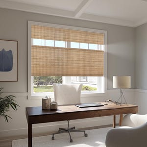 May include: A home office featuring a dark wood desk, a white chair, and a woven bamboo blind. A lamp with a beige shade is on the desk. An abstract art print hangs on the wall. The room has a neutral colour palette.