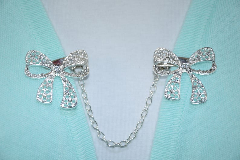 Single or double silver chain Sweater clips Large rhinestone bow Cardigan clasp