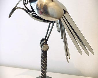 Bird on its perch made of recycled cutlery. Metal art