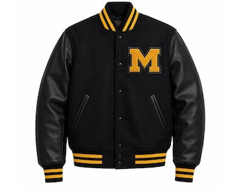 May include: A black varsity jacket featuring long black leather sleeves, a wool-blend body, and a yellow letter M patch on the left chest. The jacket includes a snap-button front closure and yellow and black striped ribbed trim on the collar, cuffs, and hem.
