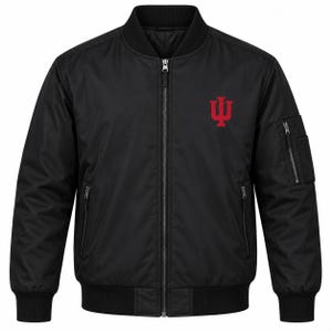 May include: A black bomber jacket featuring a full-length front zipper, ribbed collar, cuffs, and hem. The jacket includes two side pockets with zippers, a utility pocket on the left sleeve, and a red Indiana University logo on the chest.