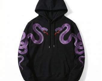 May include: Black hooded sweatshirt with embroidered purple snakes on the front and sleeves. The snakes have red and green accents. The sweatshirt has a drawstring hood and a kangaroo pocket.