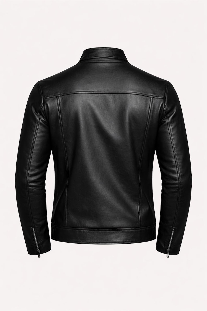 May include: Black leather jacket with a stand-up collar and zippered sleeves. The back view shows a tailored fit with a horizontal seam across the upper back. A classic, stylish outerwear piece.