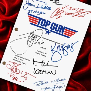 May include: A white script featuring the "Top Gun" logo and numerous signatures in different colours. The script includes text such as "Stinger", "Iceman", and "Best wishes". The background is a deep red velvet.