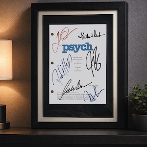 May include: A framed script page from the television show Psych, featuring the blue text "psych" and multiple black and blue ink signatures. The document includes episode details, "Last Night Gus," and is encased in a black frame with a white mat.