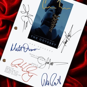 May include: A white film script cover for The Odyssey, a film by Christopher Nolan, featuring a central blue graphic of a helmeted figure. The page includes multiple handwritten signatures in various ink colours and production text details.