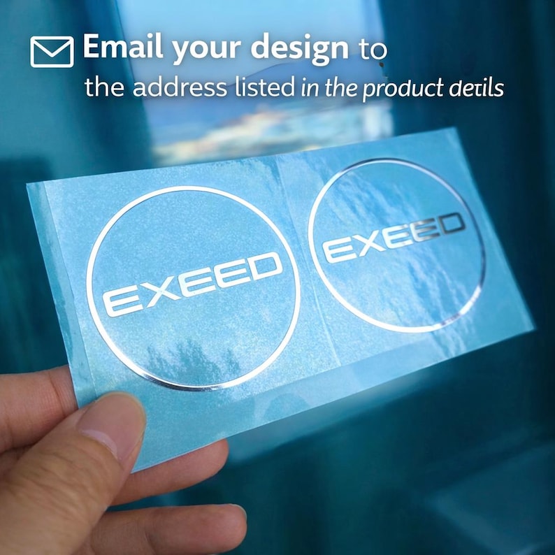 May include: Two silver-colored "EXEED" stickers on a light blue backing. The stickers are circular with the word "EXEED" in a bold, sans-serif font. The image also includes the text: "Email your design to the address listed in the product details."