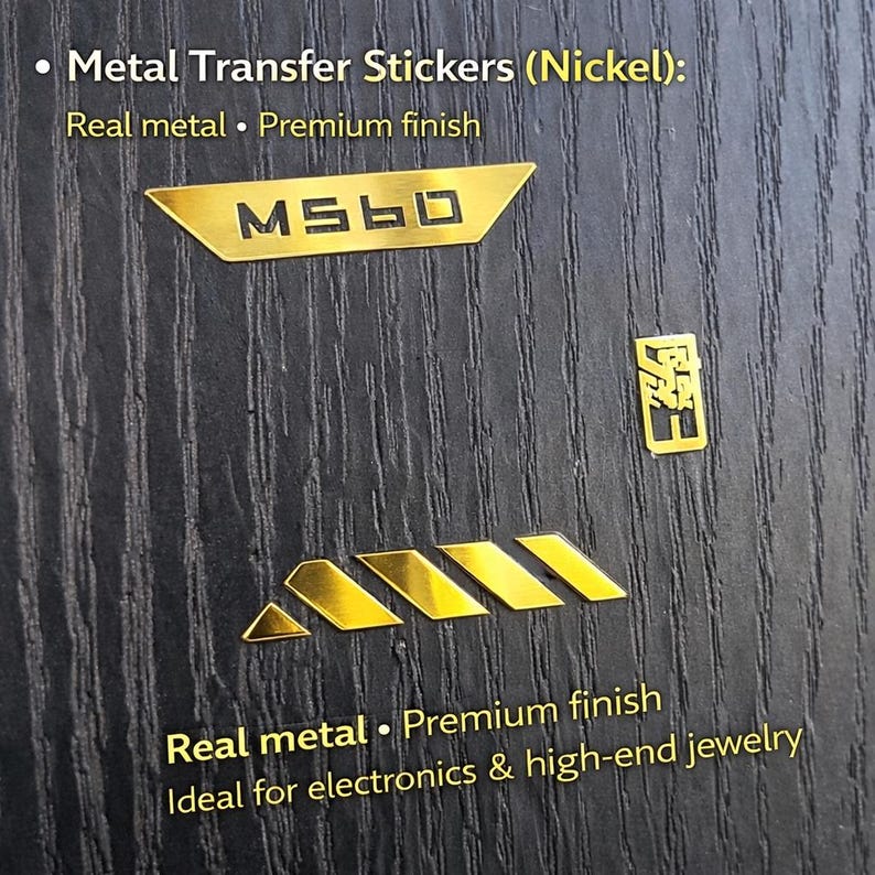 May include: Gold metal transfer stickers on a dark wood grain surface. The stickers include the text "MS60" and other geometric designs. The text "Real metal &bull; Premium finish" is also visible.
