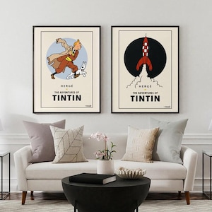Puede incluir: Dos carteles enmarcados con ilustraciones de Las aventuras de Tint&iacute;n. Uno muestra a Tint&iacute;n con Mil&uacute;, el otro un cohete. Ambos tienen un fondo crema con marcos y texto negros.