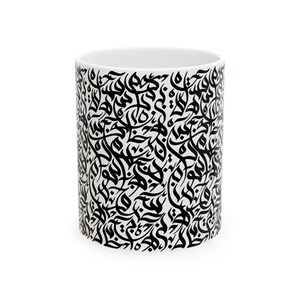 May include: White ceramic mug featuring a repeating black calligraphic pattern. The design covers the entire surface of the mug, creating a high-contrast visual effect. The mug has a standard cylindrical shape and a white interior.