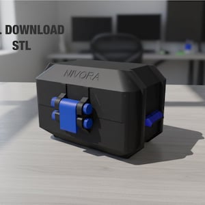 Puede incluir: Un objeto geométrico negro y azul con el texto "NIVORA" en la parte superior. El objeto tiene detalles en azul y está etiquetado como "DIGITAL DOWNLOAD STL". Está sobre una superficie clara.