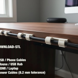 May include: White cable clips attached to a brown desk, holding a black cable. The image includes text: DIGITAL DOWNLOAD-STL, and cable sizes for USB, mouse, HDMI, and power cables.