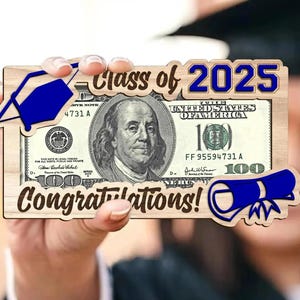 May include: A wooden graduation gift featuring a $100 bill, with the text "Class of 2025" and "Congratulations!". The design includes a blue graduation cap and diploma, perfect for celebrating a graduate.