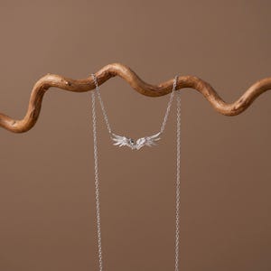 S925 silver angel wing pendant necklace, a dainty necklace ideal for layering with crosses, lockets, initials, or birthstone pieces. Elegant everyday necklace and wedding necklace for brides, bridesmaids, or anniversary gifting. Bright tarnish resistant rhodium plating, premium sterling silver craftsmanship.
