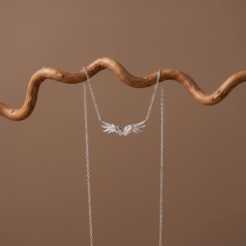 S925 silver angel wing pendant necklace, a dainty necklace ideal for layering with crosses, lockets, initials, or birthstone pieces. Elegant everyday necklace and wedding necklace for brides, bridesmaids, or anniversary gifting. Bright tarnish resistant rhodium plating, premium sterling silver craftsmanship.