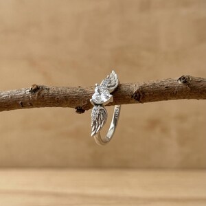 Dainty silver ring with heart shaped crystal and angel wing detailing, a premium promise ring for her crafted in S925 sterling silver, perfect as a statement ring, friendship ring, cute crystal ring or sweet gift for her on Valentine's Day, anniversary, birthday or any special celebration.