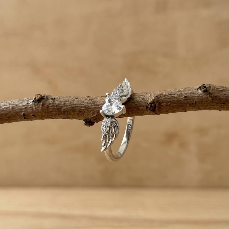 Dainty silver ring with heart shaped crystal and angel wing detailing, a premium promise ring for her crafted in S925 sterling silver, perfect as a statement ring, friendship ring, cute crystal ring or sweet gift for her on Valentine's Day, anniversary, birthday or any special celebration.